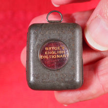 Load image into Gallery viewer, Smallest English Dictionary in the World. >>MINIATURE BRYCE DICTIONARY IN LOCKET<< Publication Date: 1900 CONDITION: GOOD