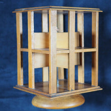 Load image into Gallery viewer, Revolving Bookcase. Slim, revolving, sycamore bookcase for miniature books. 1904.