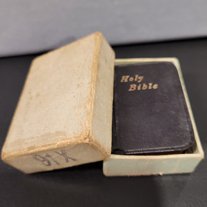 Holy Bible c1914  3/4" x 1 1/4"  Bound in black leather with gilt title to front cover and spine. Gilt edges.  Contained in an unmarked cardboard box